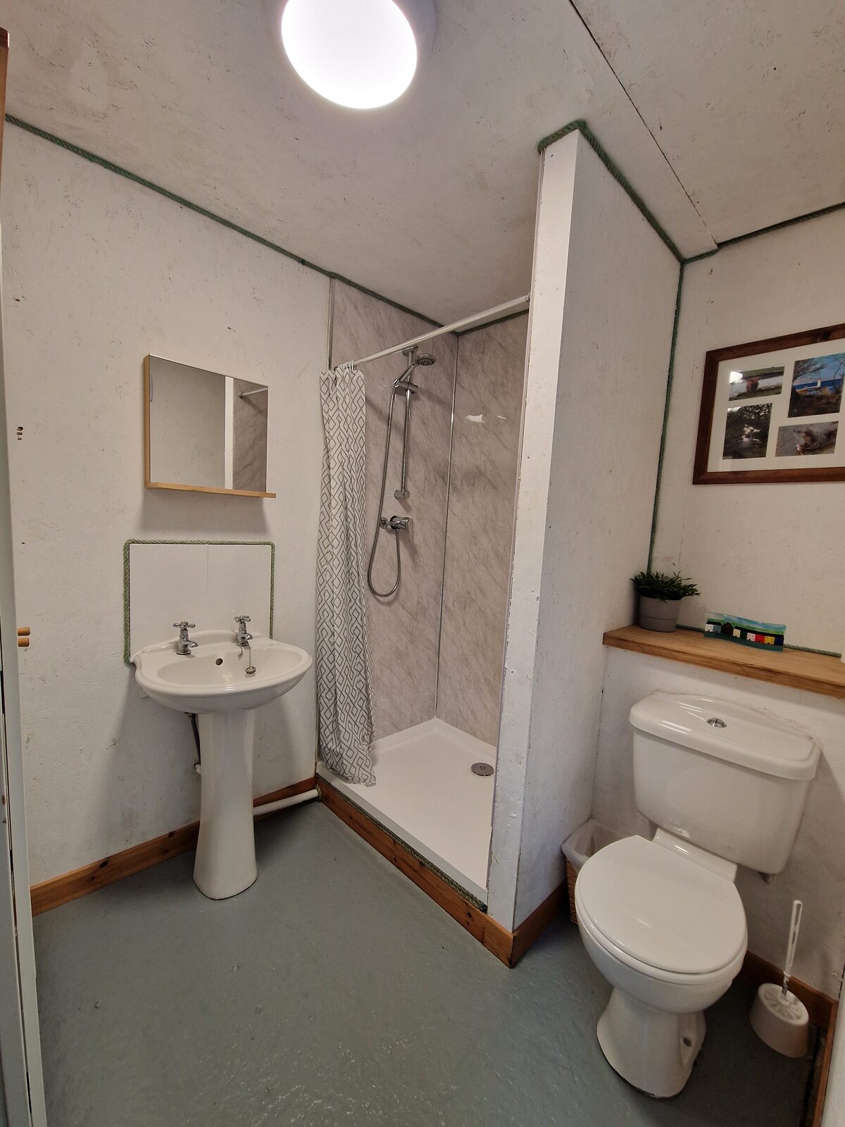 The private shower room at the visitor centre — shower, basin, and toilet